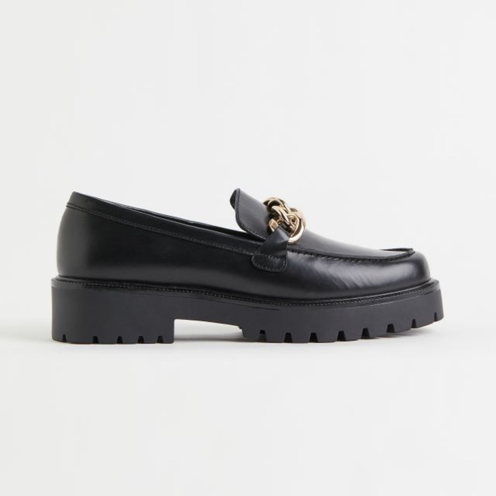 Chunky leather loafers with a gold chain detail across the front